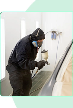 Mechanic performing vehicle detailing and repair work